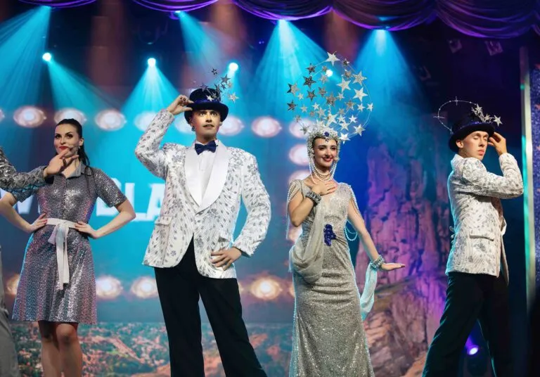 Vestuario de Chicago con corsés, lentejuelas y plumas dentro de una escena de cabaret inspirada en el musical.